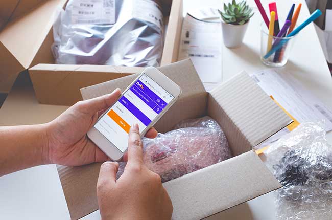 Online shopping concepts with young female buying product on smartphone and some her product on table.