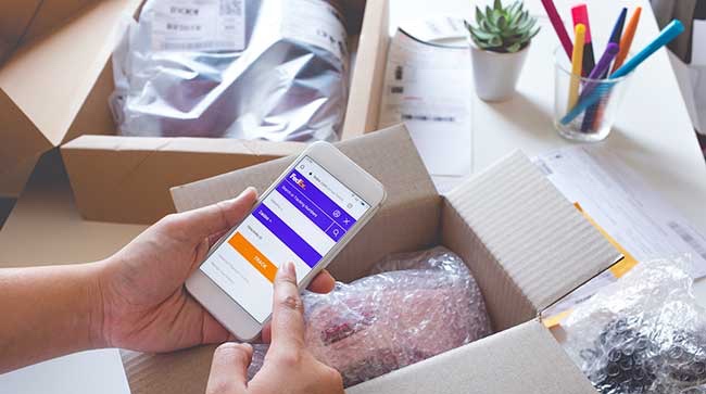 Online shopping concepts with young female buying product  on smartphone and some her product on table.