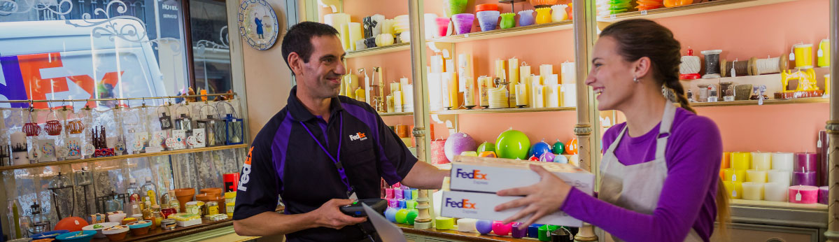 FedEx worker accepting boxes from woman