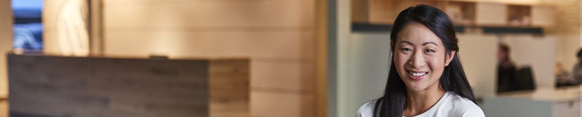 Woman holding FedEx package in building lobby