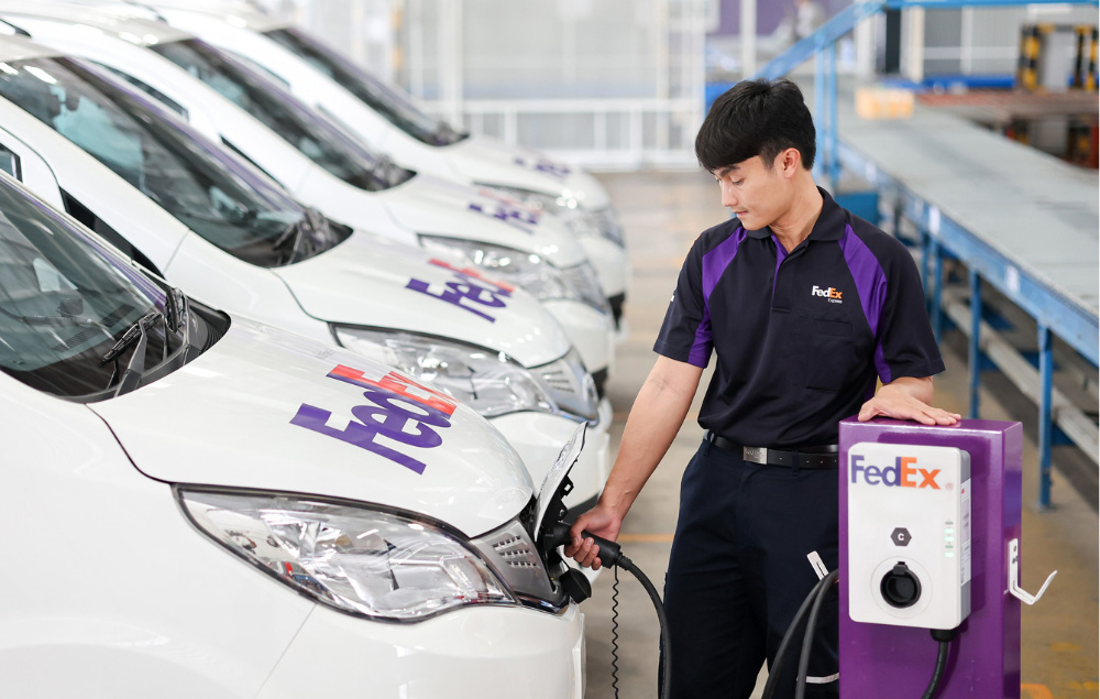 Courier plugging in electric van