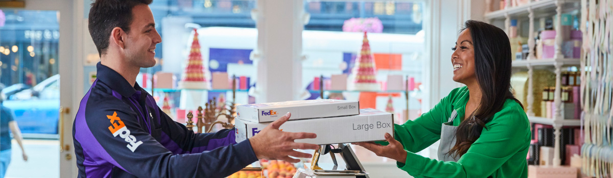 FedEx worker handing packages to a merchant