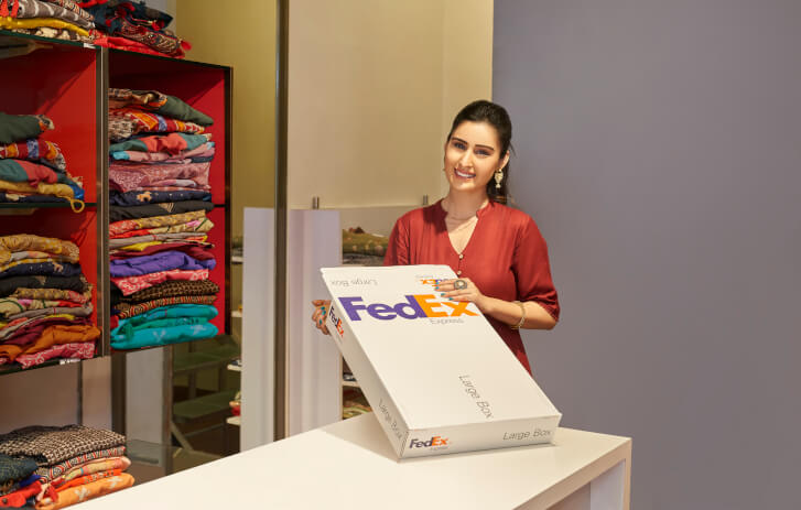 Woman opening a FedEx package