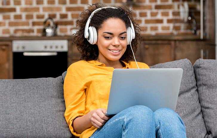 woman listening to webinar on laptop