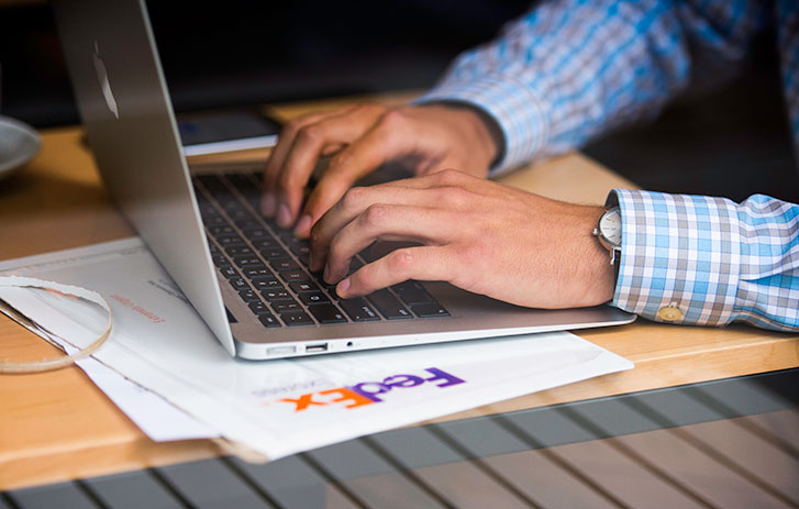 A person typing on a laptop