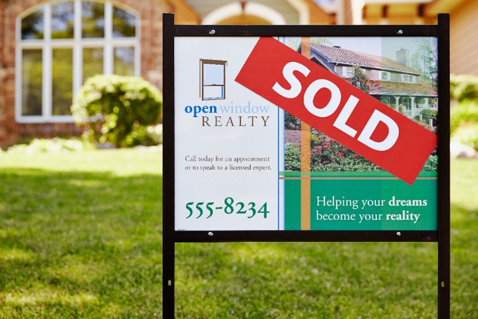 Sold metal sign in yard Sold metal sign in yard