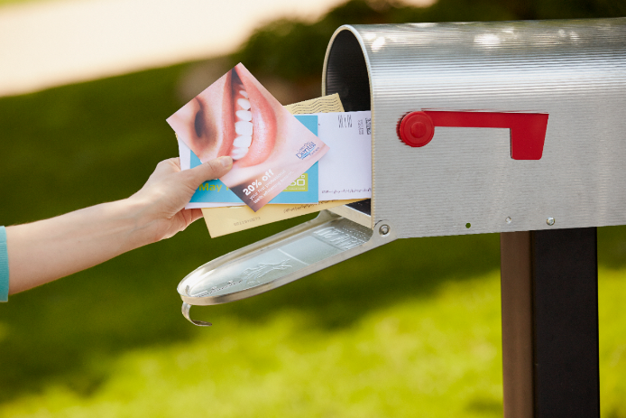 Direct Mail Services Direct mail being pulled out of a mailbox