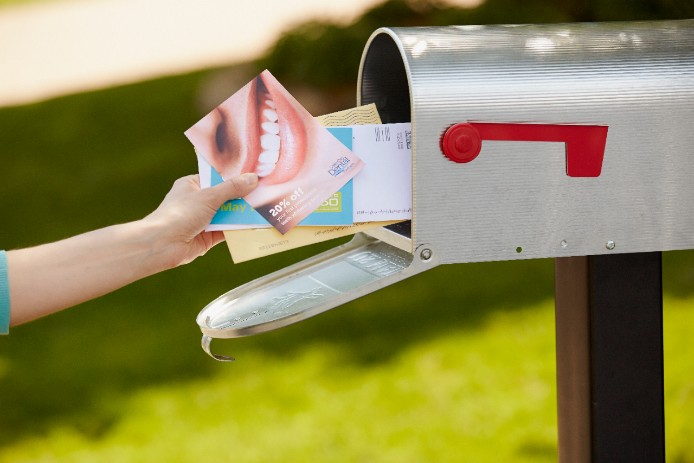 Direct Mail Services Direct mail being pulled out of a mailbox