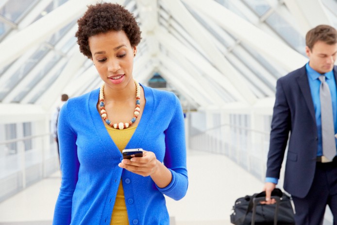 woman walking while on cell phone