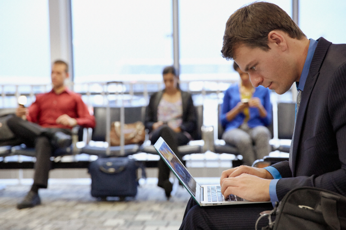 man on laptop in airport