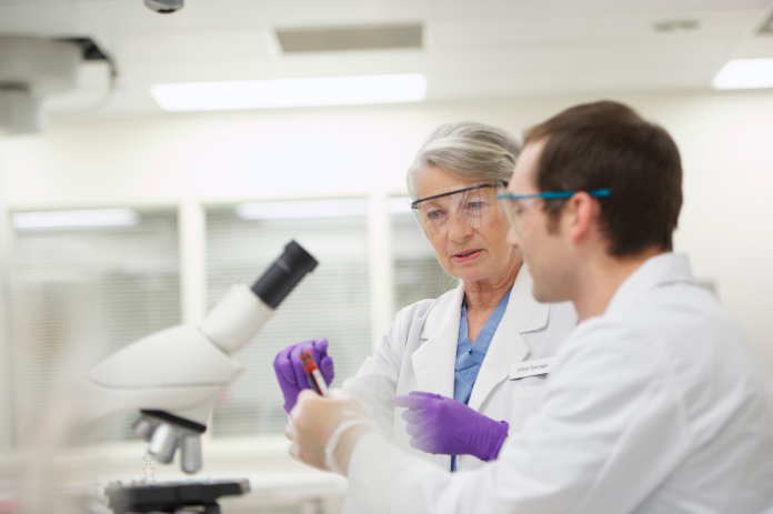 Lab technicians working together while testing dangerous goods