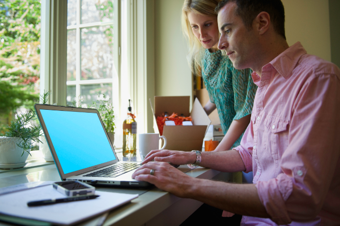 Man and woman working on laptop