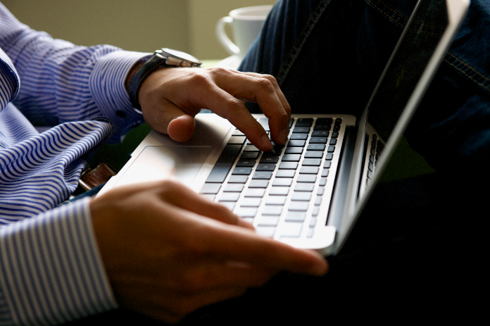 Person typing on laptop