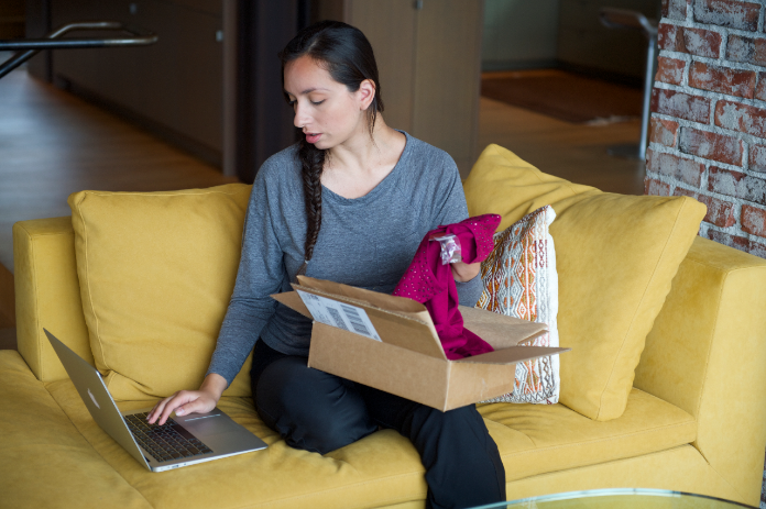 Woman using laptop to return shipments