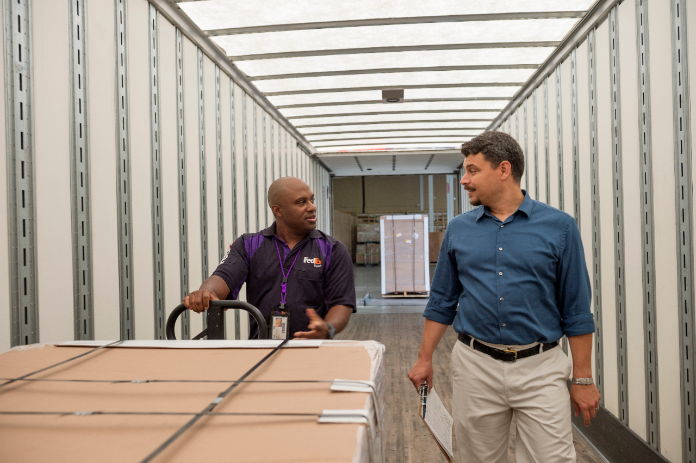 Courier moves large shipment at warehouse