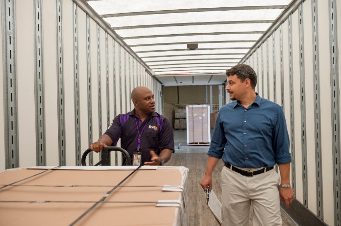 Courier moves large shipment at warehouse