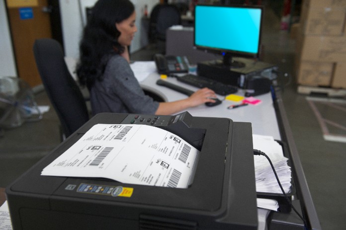 Women printing out shipping labels