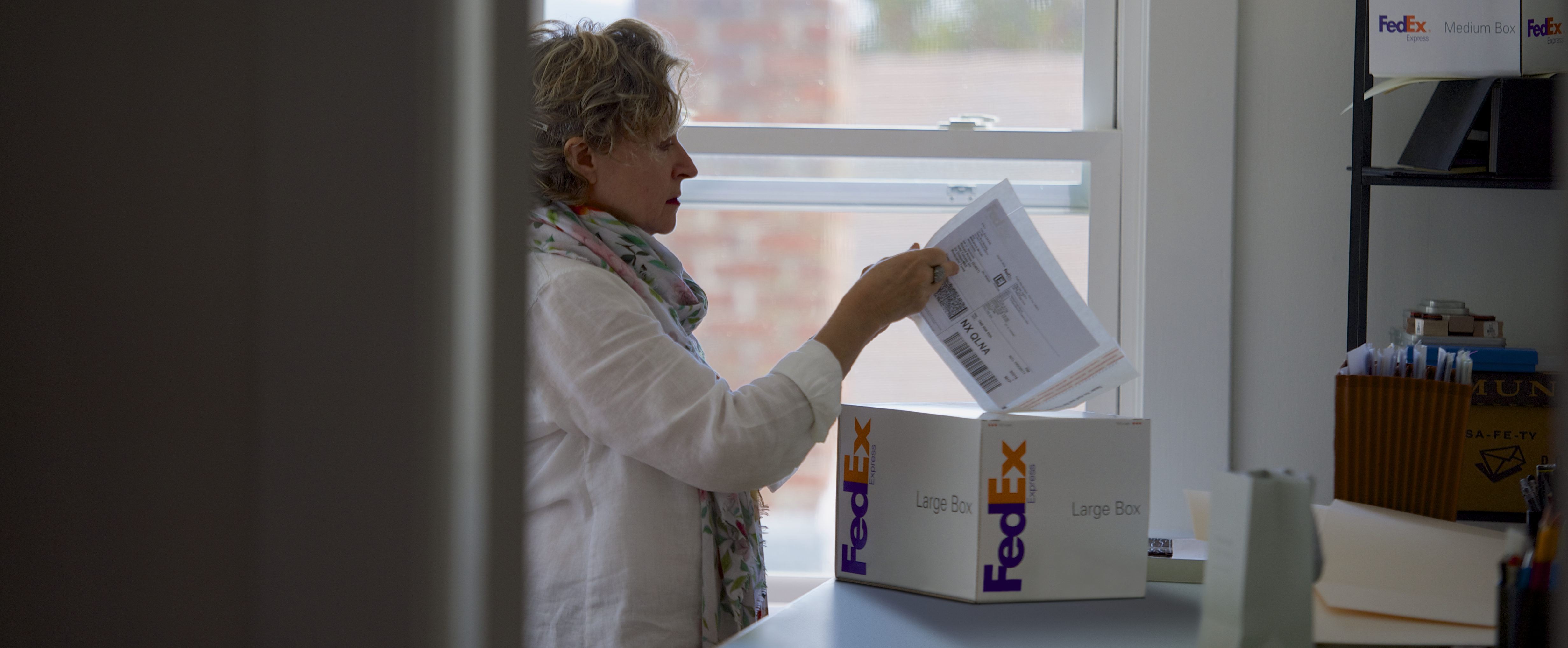 Woman attaching a return label to a package