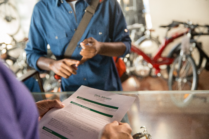 Handing resume to employer Job seeker handing resume to employer