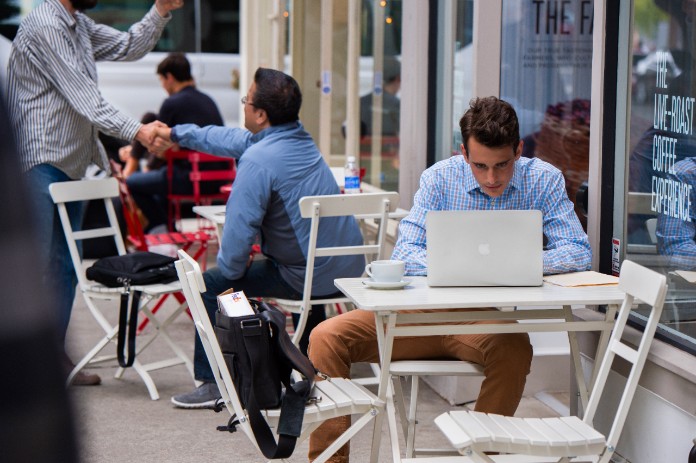 Man at restaurant on computer