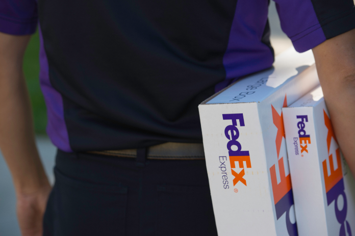 Courier carries two FedEx boxes