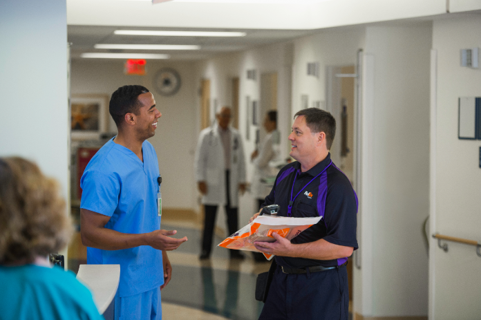 Courier delivers package to doctor in medical building