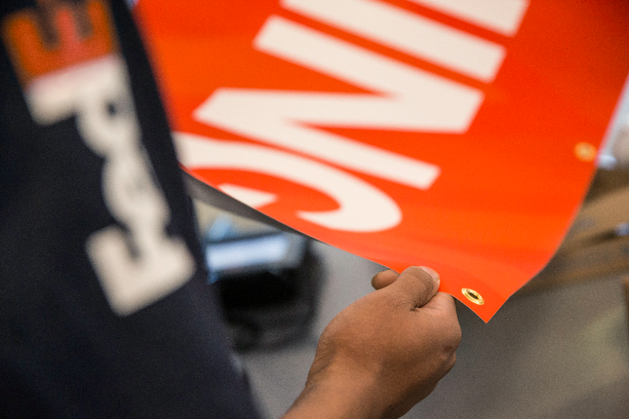 FedEx employee rolling a banner FedEx employee rolling a banner
