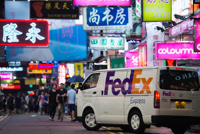 FedEx Express Van driving through international streets