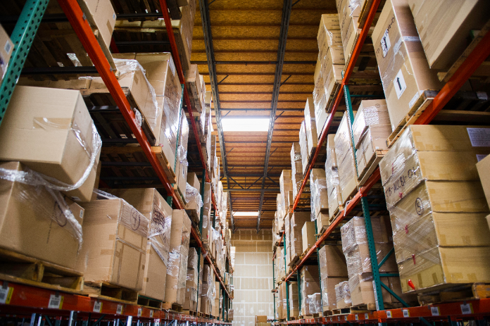 Multiple industrial palette racks store packages in a warehouse facility.