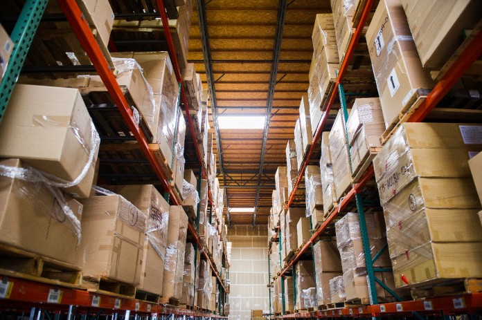 Multiple industrial palette racks store packages in a warehouse facility.