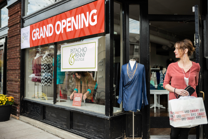 Grand Opening Banner Customer walking by a grand opening banner