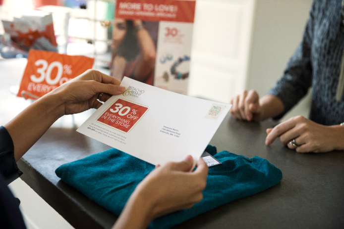 A customer reviewing a postcard