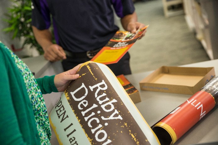 Customers unrolling posters Customers unrolling posters for a food truck
