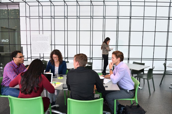 Five people at table in office conference room