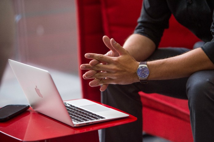 Man sitting down using laptop