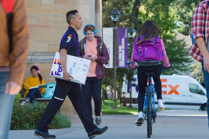 FedEx courier walking on college campus