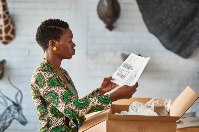 A woman prepares to use a FedEx return label.