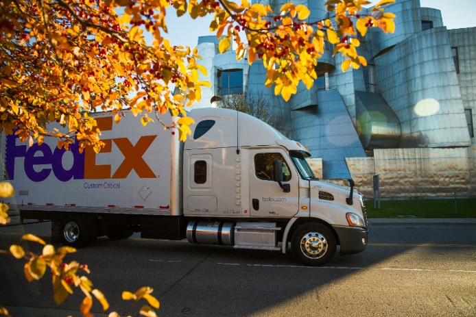 FedEx Custom Critical truck drives outside metal building