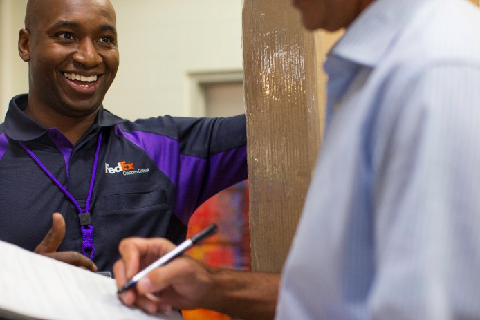 A FedEx courier prepares to take a Custom Critical delivery