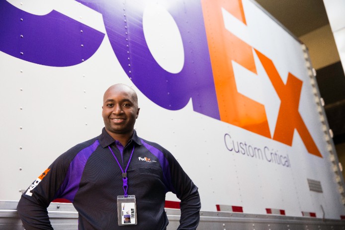A FedEx courier is about to deliver a Custom Critical package.