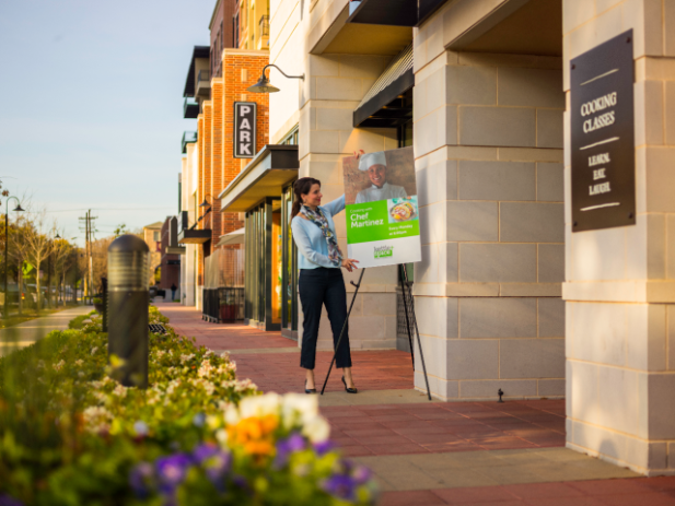 Customer adjusting a mounted poster