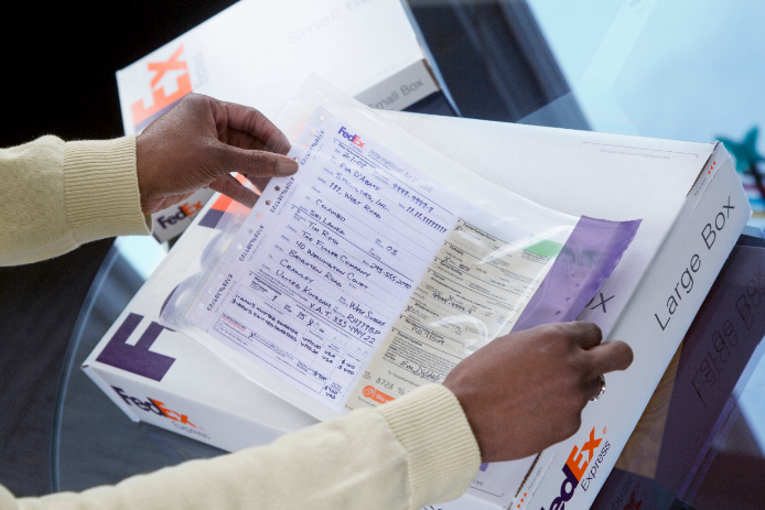 Person applying packaging label to box