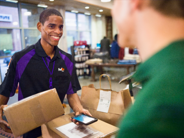 A courier scans and affixes return labels onto packages