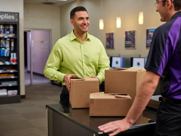FedEx employee inspecting boxes FedEx employee inspecting boxes