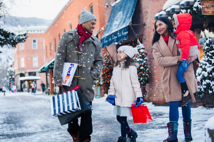 Family in snow with FedEx packages