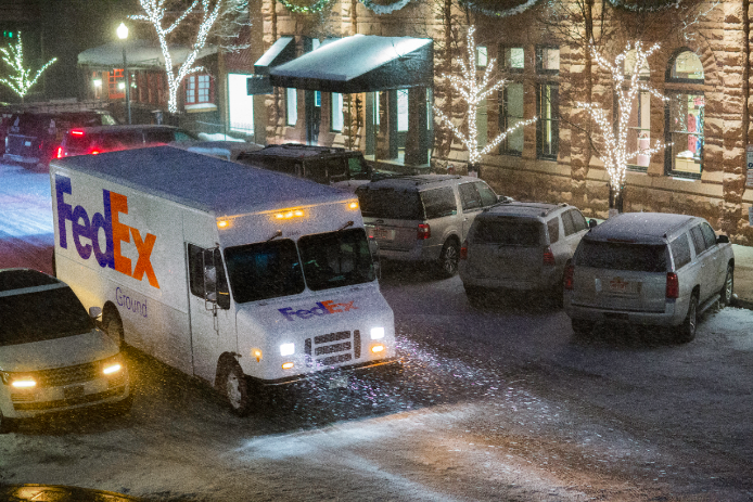 FedEx Ground truck driving on snowy street