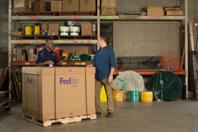 A FedEx courier delivers a larger-scale LTL shipment
