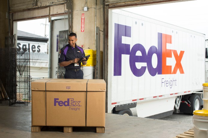 A FedEx courier picks up a FedEx Freight Priority shipment.