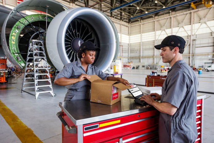 A FedEx Express employee uses SenseAware to track a delivery