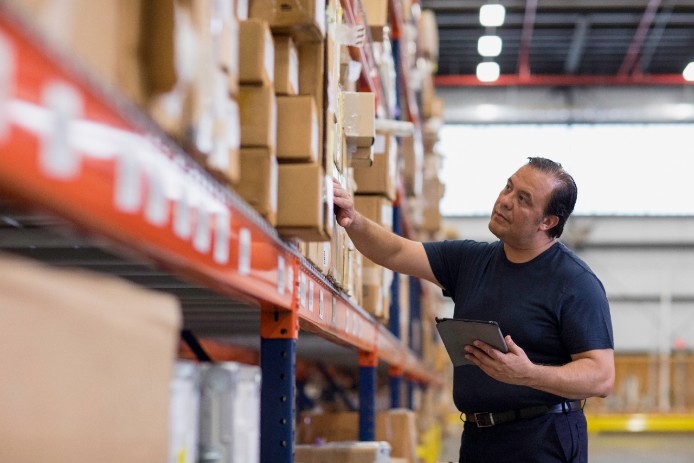 Man checking packages in warehouse